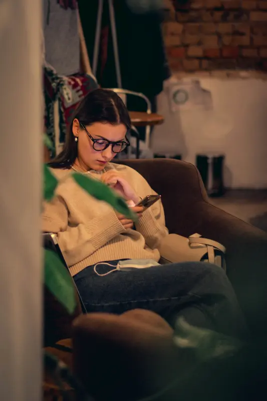 Person using color analysis fabric swatches at home in natural lighting