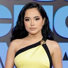 Editorial gallery of Becky G styled in bright winter looks with electric blues, magenta accents, and polished black, highlighting electric cobalt, icy magenta, optic white, chrome silver, and inky black.