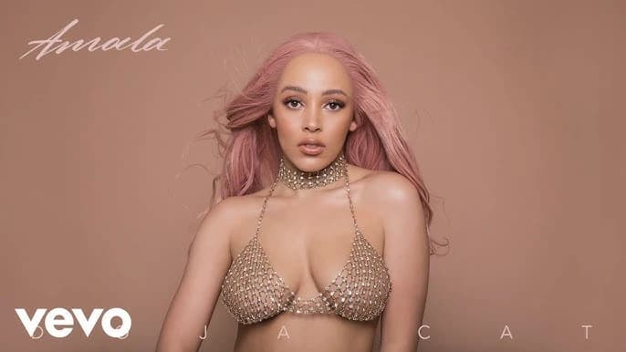Editorial gallery of Doja Cat styled in bright winter looks with electric blues, magenta accents, and polished black, highlighting magenta, chrome, optic white, ultraviolet, and blood red.
