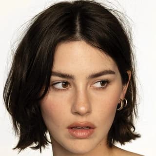 Gracie Abrams wearing cool-toned looks with berry accents and fluid movement, showcasing powder blue, soft lilac, rose quartz, silvery sage, and midnight plum from the True Summer palette.