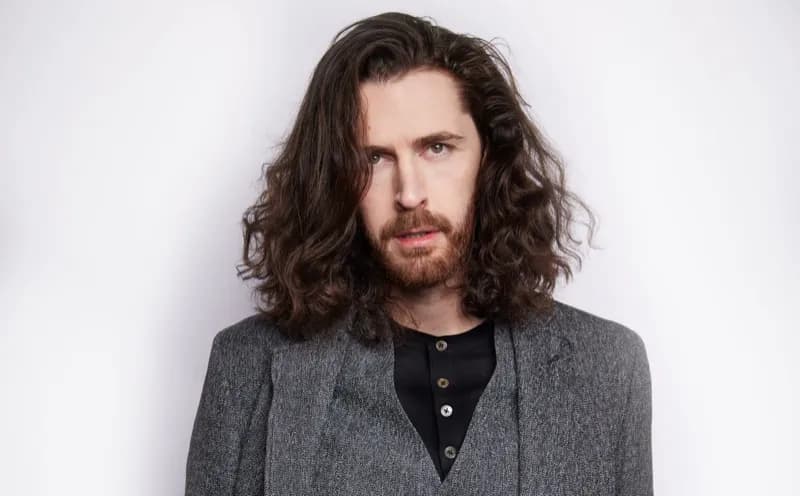 Editorial gallery of Hozier styled in bright winter looks with electric blues, magenta accents, and polished black, highlighting electric cobalt, icy magenta, optic white, chrome silver, and inky black.
