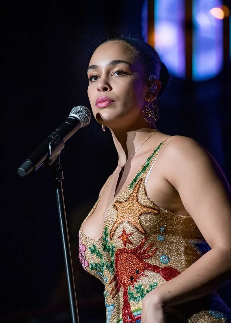 Jorja Smith wearing jewel-toned statement dressing with crisp contrast and sparkle, showcasing electric cobalt, icy magenta, optic white, chrome silver, and inky black from the Bright Winter palette.