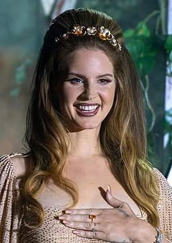 Editorial gallery of Lana Del Rey styled in soft autumn looks mixing moss green, terracotta, and bronzed neutrals, highlighting desert rose, sage green, oatmeal, copper brown, and soft teal.