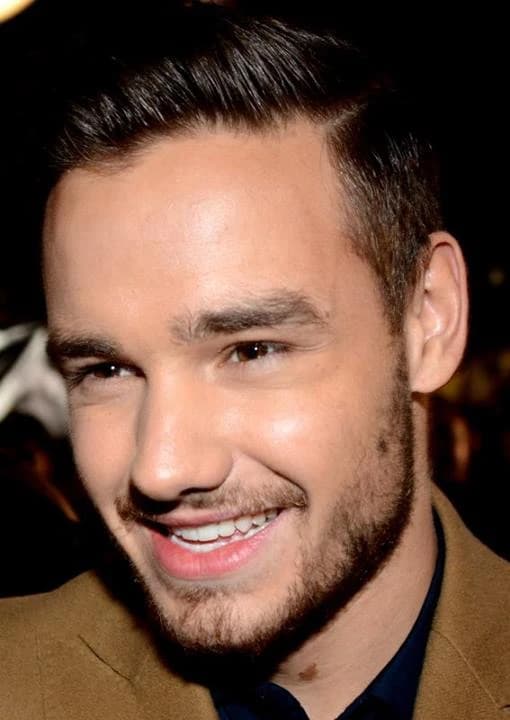 Liam Payne wearing jewel-toned statement dressing with crisp contrast and sparkle, showcasing electric cobalt, icy magenta, optic white, chrome silver, and inky black from the Bright Winter palette.