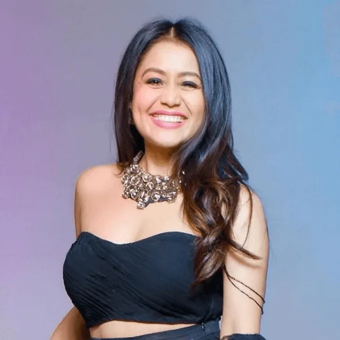 Editorial gallery of Neha Kakkar styled in vibrant autumn outfits featuring saffron, teal, and gold hardware, highlighting sunset coral, electric apricot, teal flash, buttery ivory, and gold shimmer.