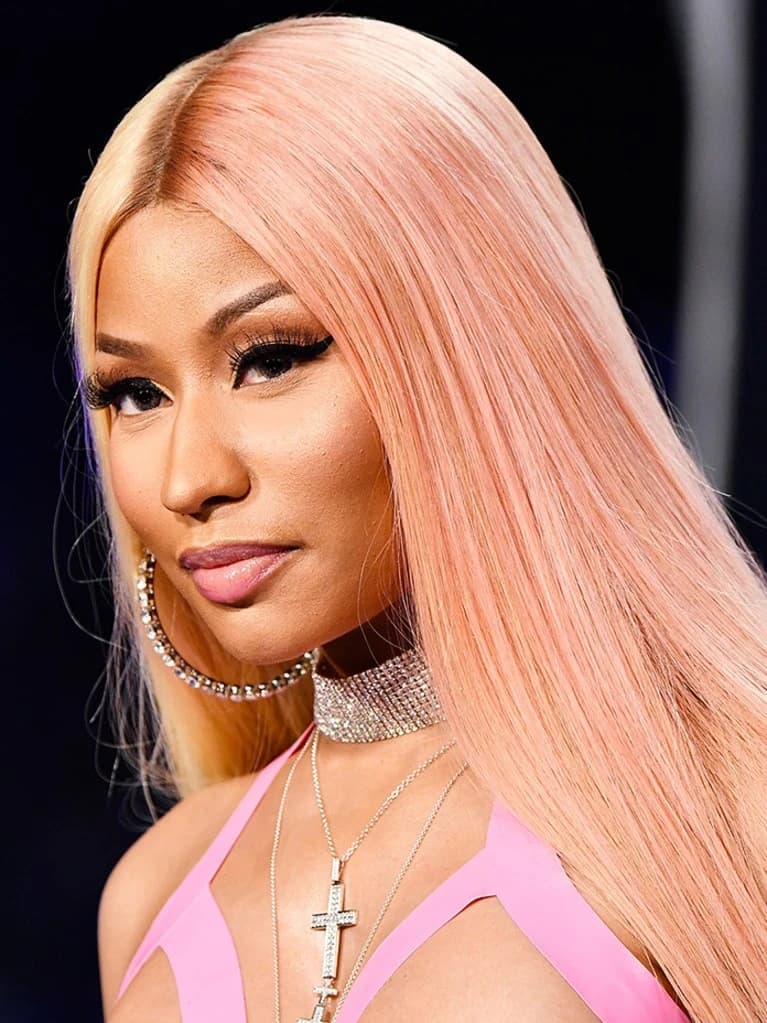 Editorial gallery of Nicki Minaj styled in bright winter looks with electric blues, magenta accents, and polished black, highlighting electric cobalt, icy magenta, optic white, chrome silver, and inky black.