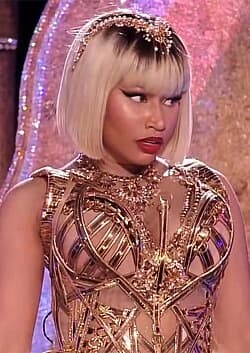 Nicki Minaj wearing jewel-toned statement dressing with crisp contrast and sparkle, showcasing electric cobalt, icy magenta, optic white, chrome silver, and inky black from the Bright Winter palette.