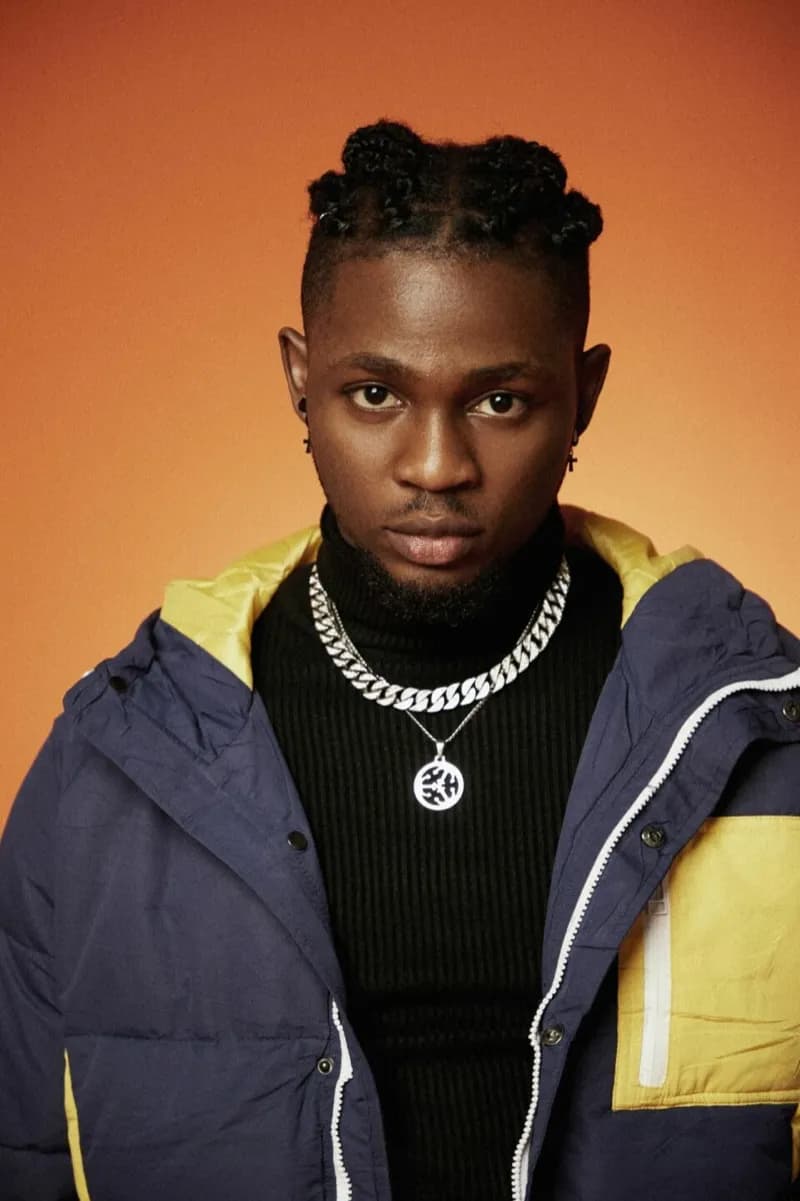 Editorial gallery of Omah Lay styled in vibrant autumn outfits featuring saffron, teal, and gold hardware, highlighting burnt sienna, chartreuse, emerald, molten gold, and espresso.
