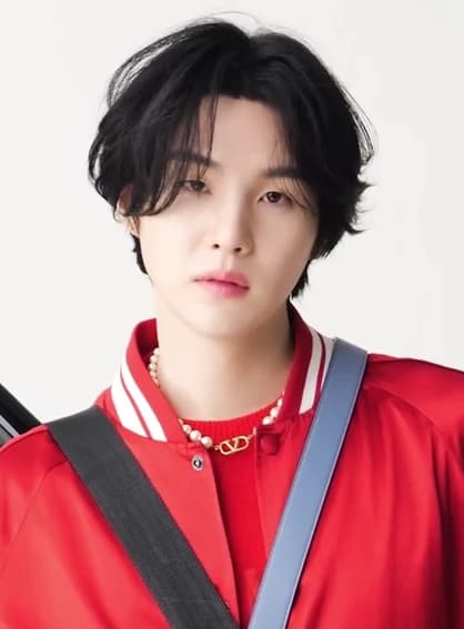 Suga (BTS) wearing high-contrast electric brights paired with sharp tailoring, showcasing ultra violet, neon fuchsia, electric jade, polished pewter, and onyx from the Bold Winter palette.
