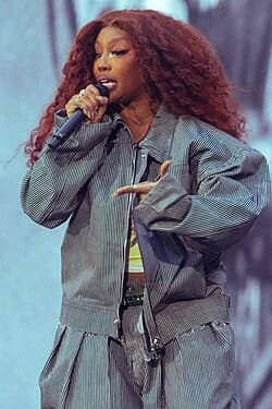 SZA wearing muted autumn ensembles with velvety textures and gentle warmth, showcasing seafoam, sage, rust, warm clay, and moss from the Soft Autumn palette.