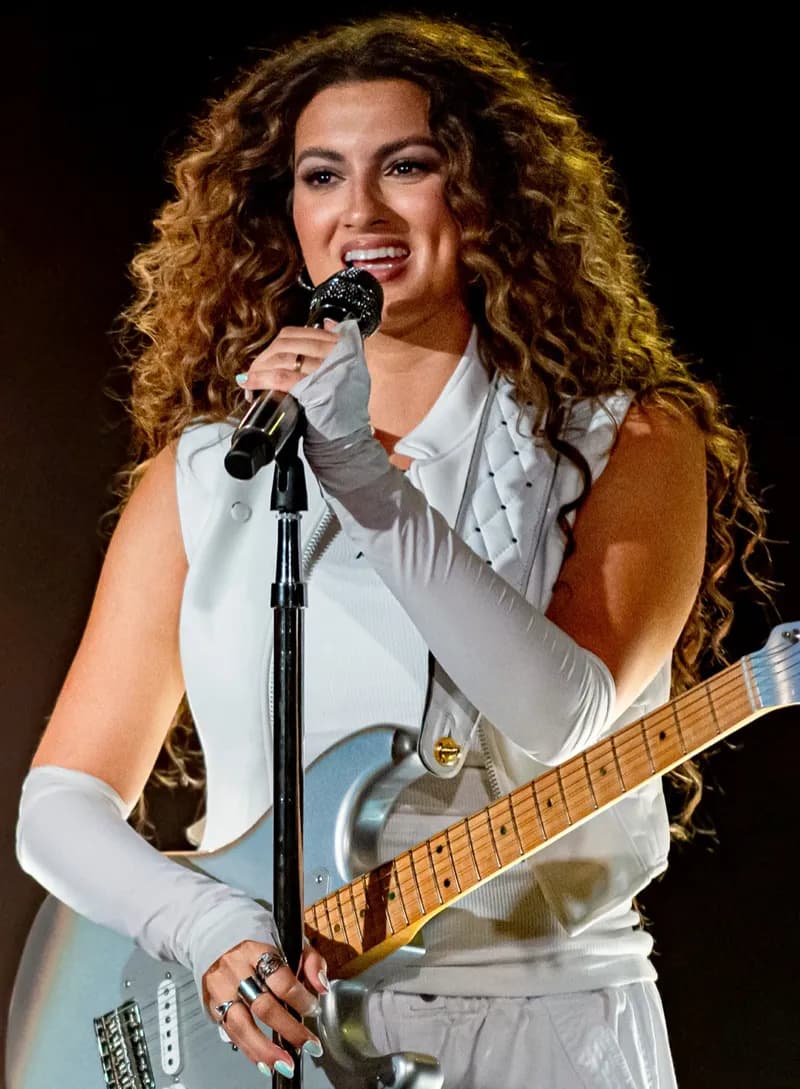 Tori Kelly wearing velvety pastel looks with cool-muted tones, showcasing heather gray, dusty mauve, mist blue, slate green, and antique silver from the Soft Summer palette.