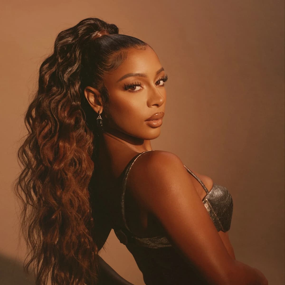 Editorial gallery of Victoria Monét styled in soft autumn looks mixing moss green, terracotta, and bronzed neutrals, highlighting desert rose, sage green, oatmeal, copper brown, and soft teal.