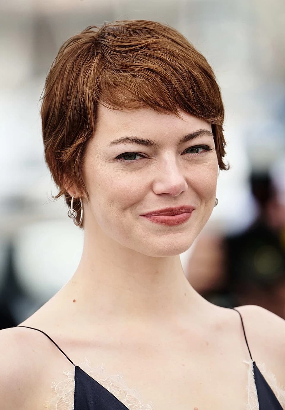 Emma Stone wearing saturated autumn looks with molten metallics, showcasing tomato red, chartreuse, copper, deep teal, and sunny marigold from the Vibrant Autumn palette.