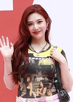 Joy (Red Velvet) — Bright Winter color palette | Palette Hunt Joy (Red Velvet) wearing jewel-toned statement dressing with crisp contrast and sparkle, showcasing electric cobalt, icy magenta, optic white, chrome silver, and inky black from the Bright Winter palette.