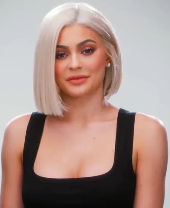 Kylie Jenner — Neutral Winter color palette | Palette Hunt Kylie Jenner wearing balanced jewel-toned looks with cool neutrals, showcasing onyx, graphite, powder pink, optic white, and silver chrome from the Neutral Winter palette.