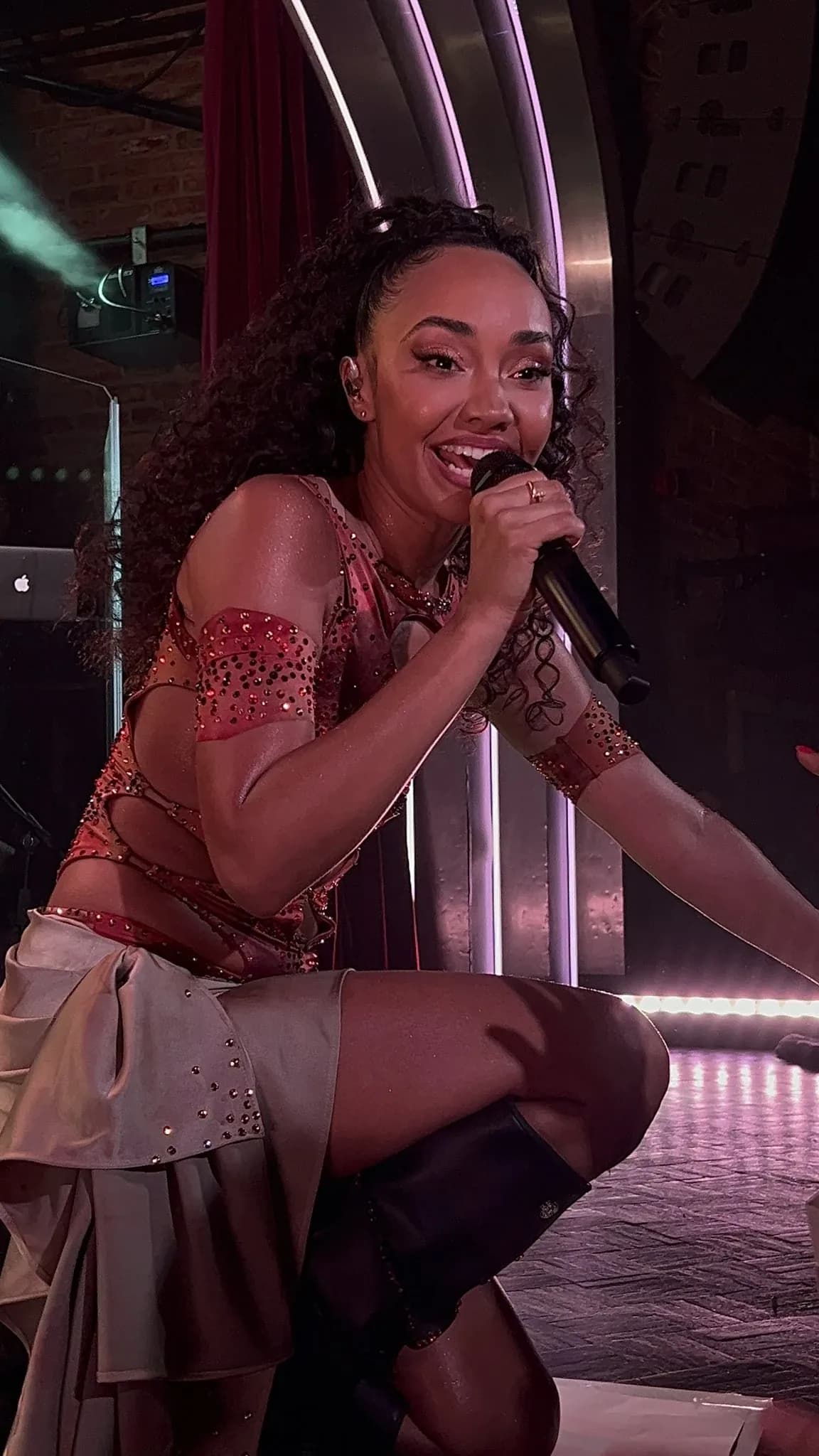 Leigh-Anne Pinnock wearing burnished metallic suiting with autumnal depth, showcasing topaz gold, jungle green, brick orange, cranberry velvet, and espresso from the Deep Autumn palette.