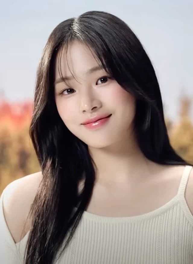 Minji (NewJeans) wearing velvety pastel looks with cool-muted tones, showcasing baby blue, lavender, mist gray, soft navy, and peachy pink from the Soft Summer palette.