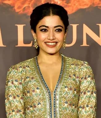 Rashmika Mandanna — Warm Spring color palette | Palette Hunt Rashmika Mandanna wearing luminous spring outfits with juicy warm hues, showcasing sunny apricot, turquoise lagoon, warm coral, buttercream, and leaf green from the Warm Spring palette.
