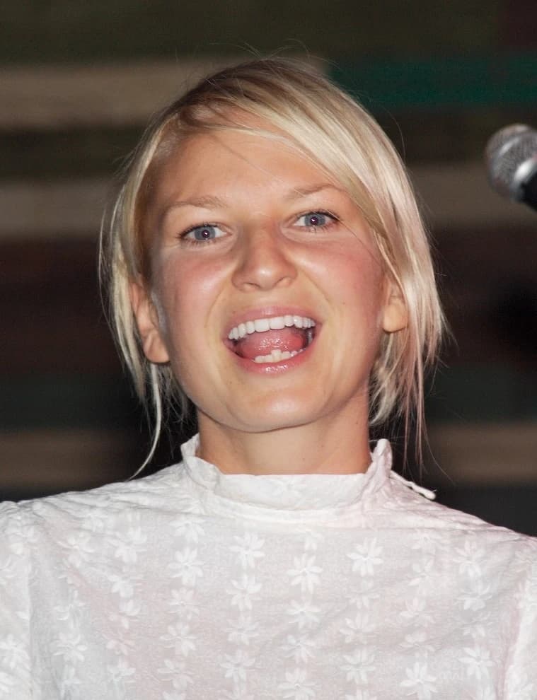 Sia wearing glowing pastel outfits with warm undertones, showcasing peach sorbet, seafoam, buttercream, leafy green, and rose beige from the Soft Spring palette.