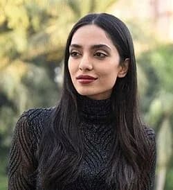 Sobhita Dhulipala wearing burnished metallic suiting with autumnal depth, showcasing merlot silk, teal sapphire, bronze cedar, spiced orange, and coffee brown from the Deep Autumn palette.