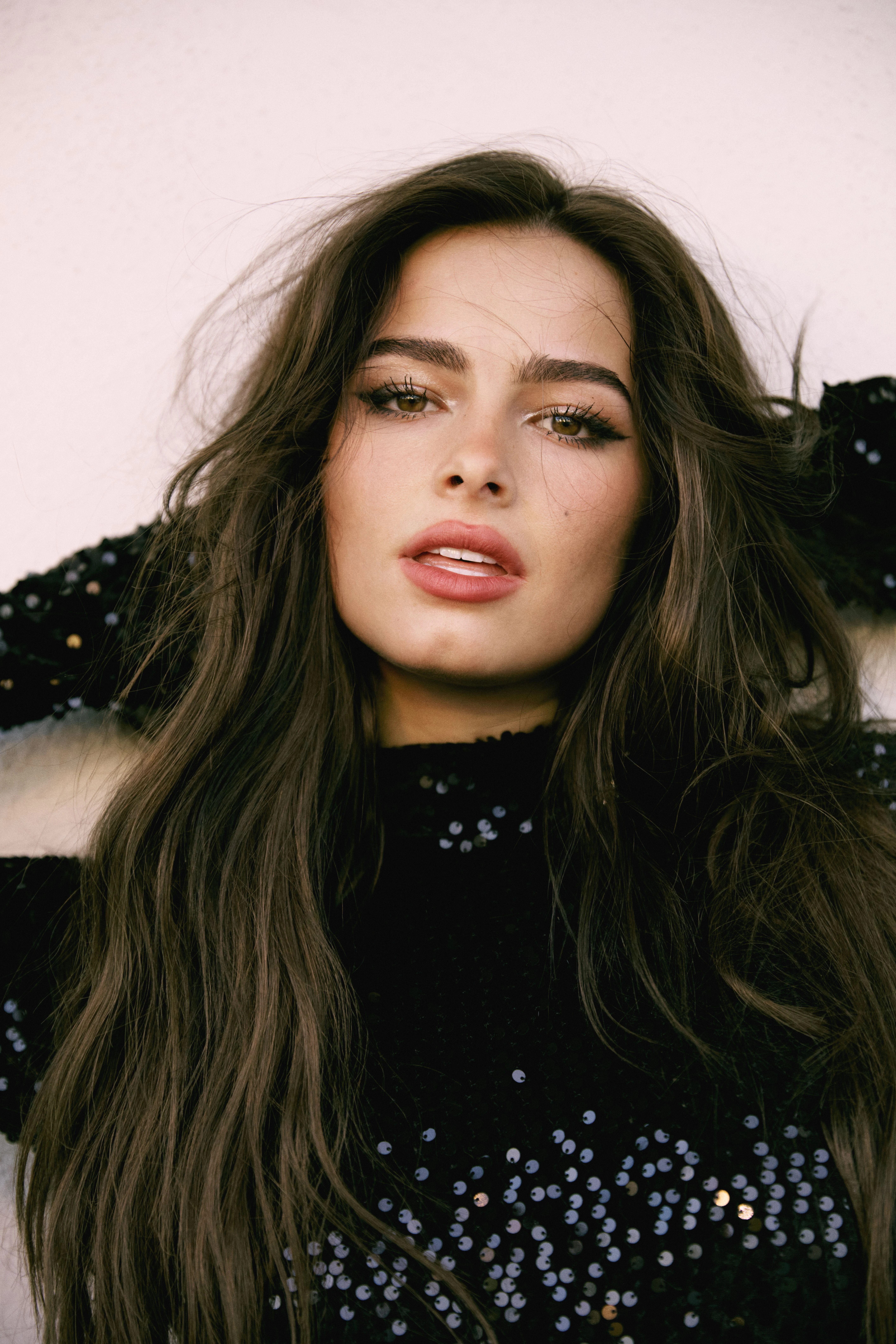 Addison Rae wearing luminous spring outfits with juicy warm hues, showcasing peach, lemon, turquoise, coral, and ivory from the Warm Spring palette.