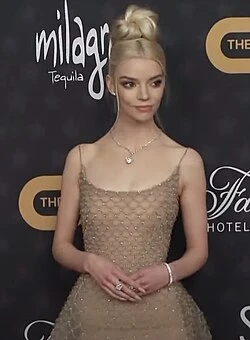 Anya Taylor-Joy wearing cool jewel-toned gowns with sharp contrast, showcasing frosted lavender, ice blue, black, magenta, and white gold from the Cool Winter palette.