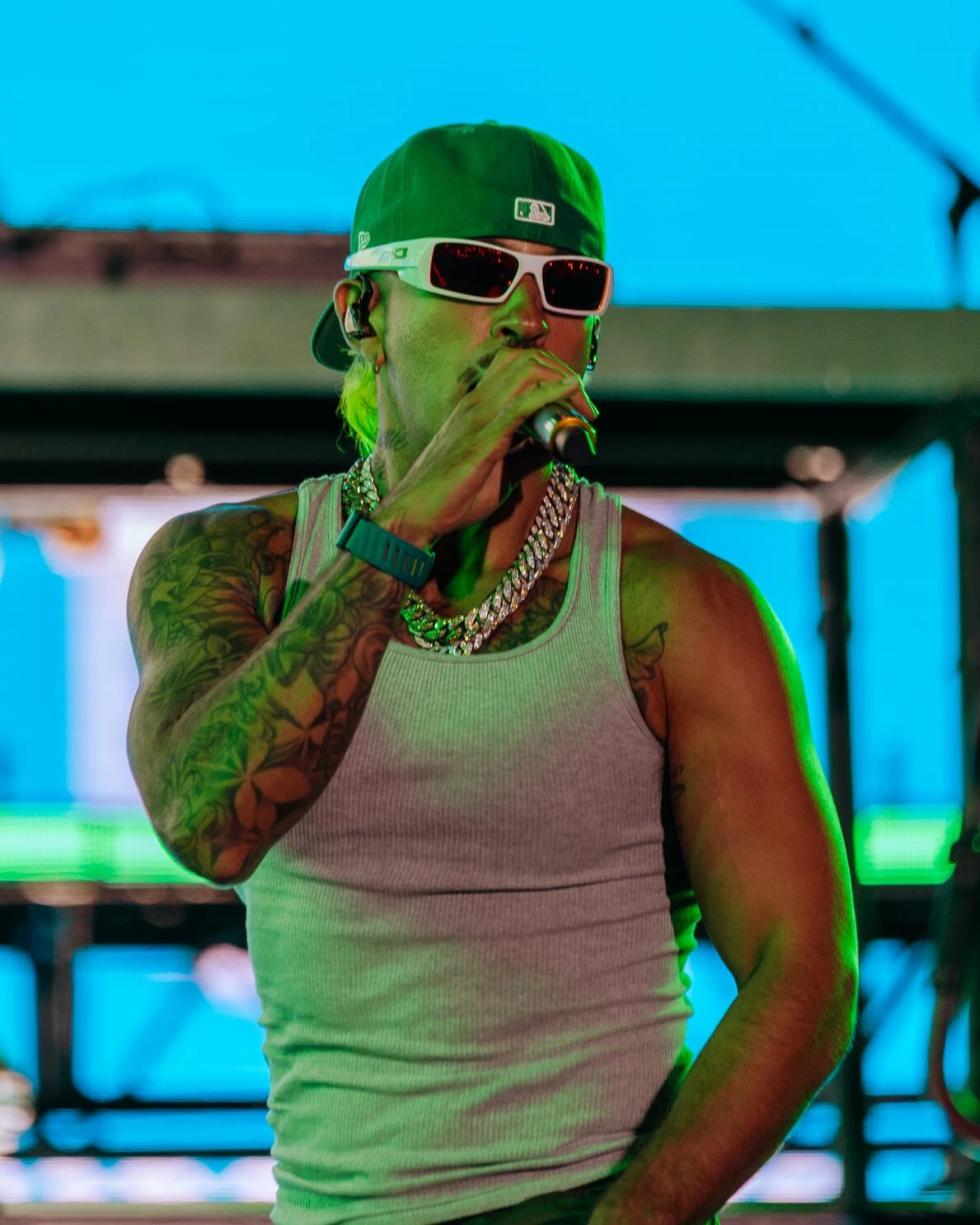 Feid wearing sunshine pastel outfits with fluid fabric and glow, showcasing sherbet peach, sea glass, buttermilk, mint foam, and rose coral from the Light Spring palette.