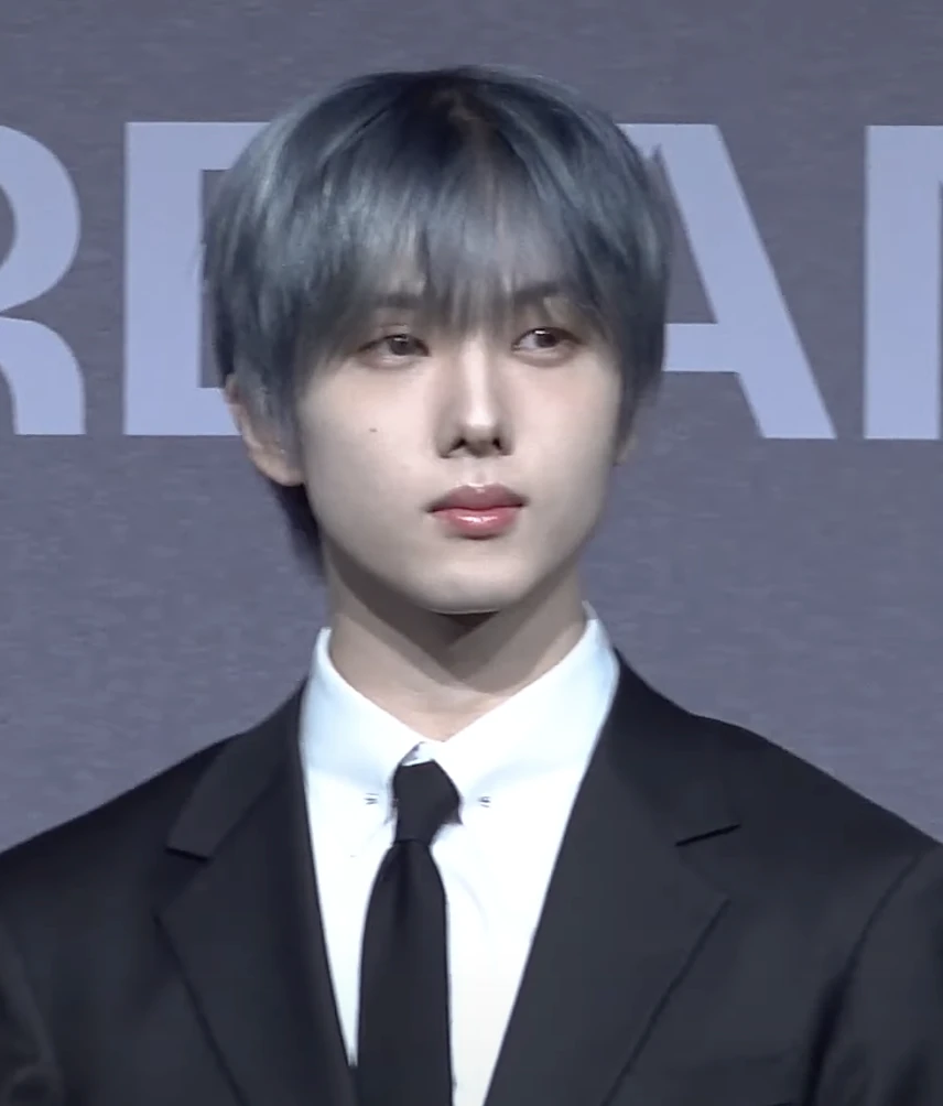 Jisung (NCT) wearing balanced jewel-toned looks with cool neutrals, showcasing steel blue, cranberry, optic white, graphite, and imperial purple from the Neutral Winter palette.