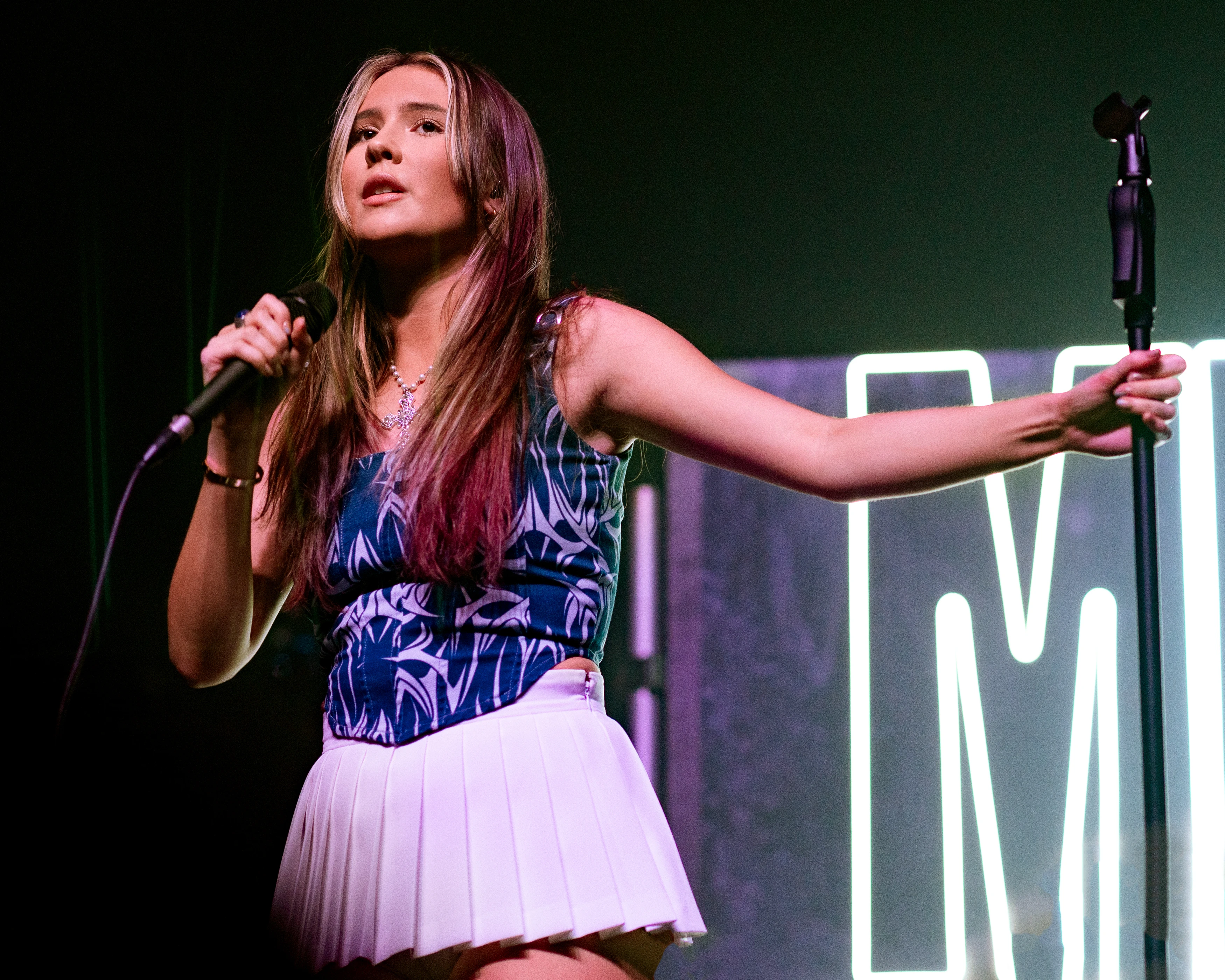 Mimi Webb wearing sunshine pastel outfits with fluid fabric and glow, showcasing sherbet peach, sea glass, buttermilk, mint foam, and rose coral from the Light Spring palette.